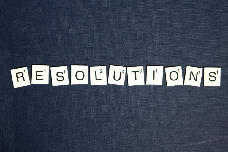 Scrabble letters spelling out 'RESOLUTIONS'