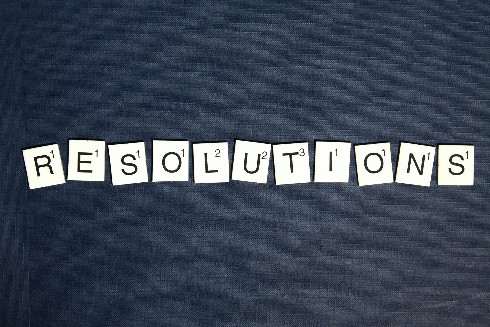 Scrabble letters spelling out 'RESOLUTIONS'