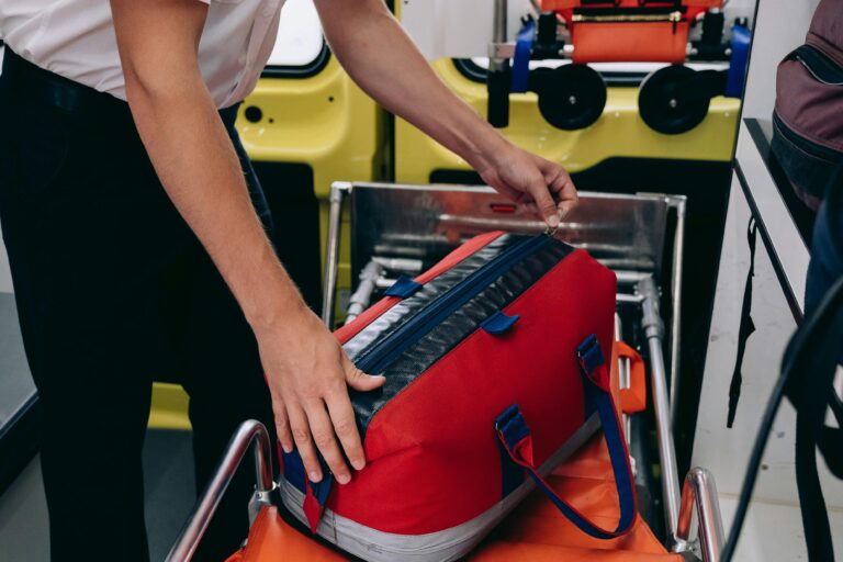 Man reaching into a red medical bag