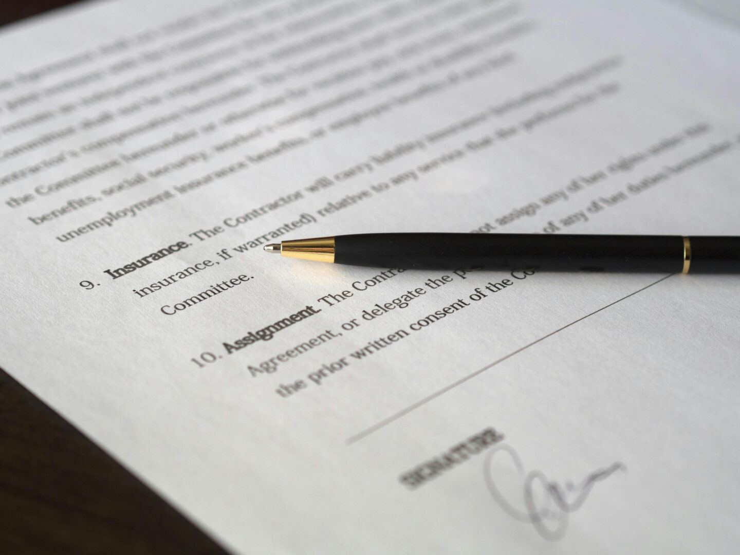 Signed document with pen on table